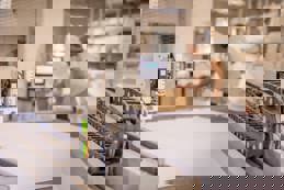 Factory worker operating CNC digital cutter for textile and fabric printing production