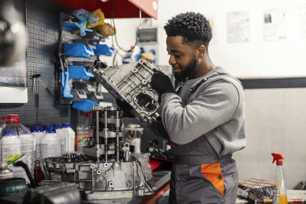 Repairman fixing car engine