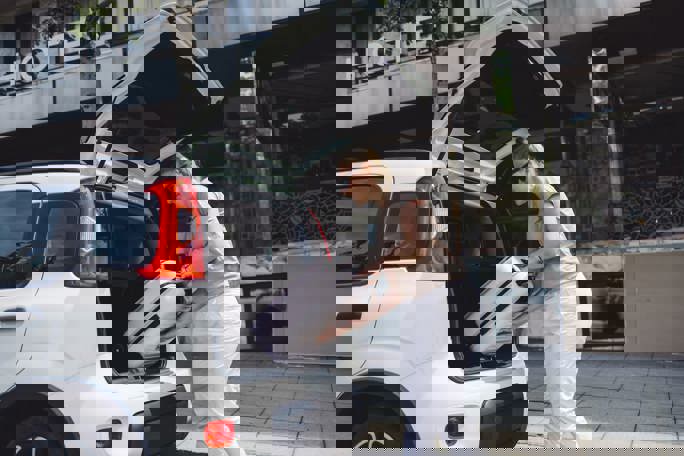 Loading suitcase into car 