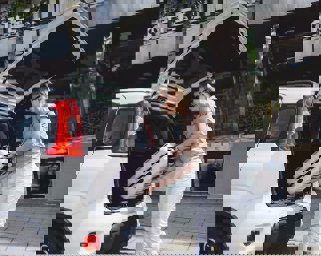 Loading suitcase into car 