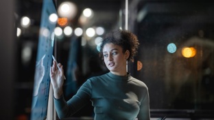 woman looking at a board in office
