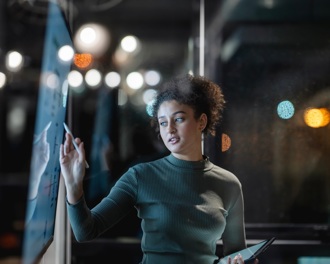 woman looking at a board in office
