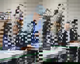 Teacher helping student