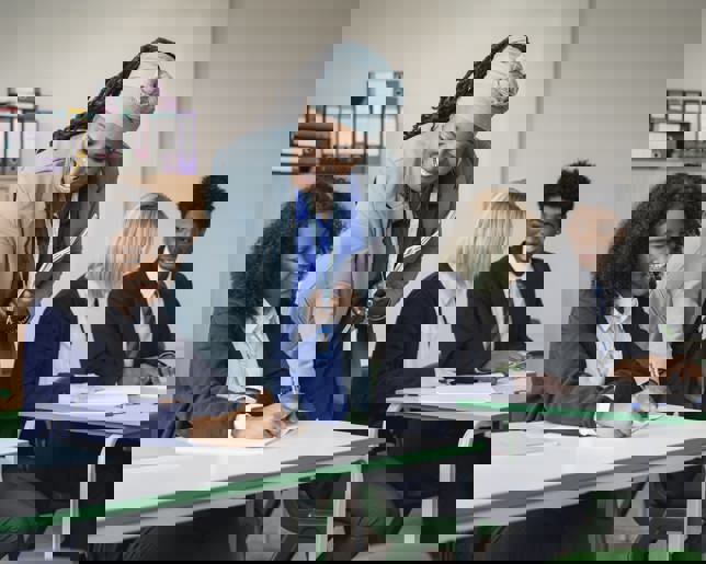 Teacher helping student