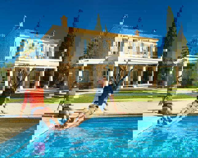 Couple enjoying pool rural home