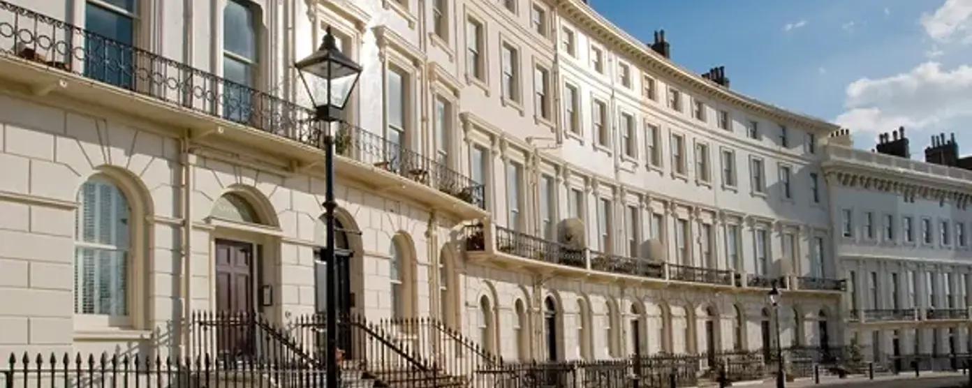 Elegant Regency-style terraced houses with balconies, tall sash windows
