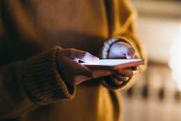 A pair of hands using a smart phone