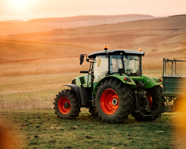 Tractor and trailer transporting harvest