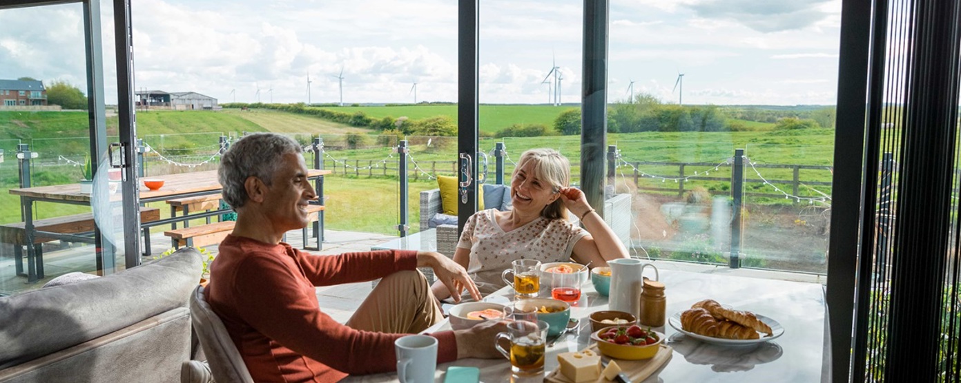 couple sitting at a cafe table laughing