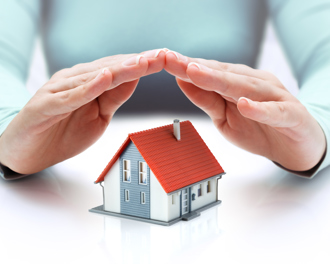 A pair of hands supports a tiny house, representing the idea of safeguarding homes through protection or insurance.