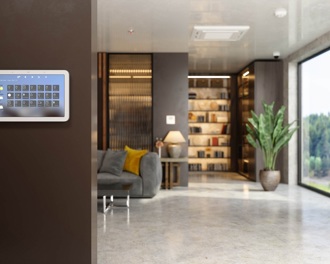 A home security system on the wall of an open plan living room