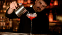 Bartender pours cocktail