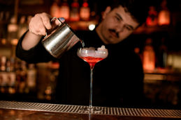 Bartender pours cocktail