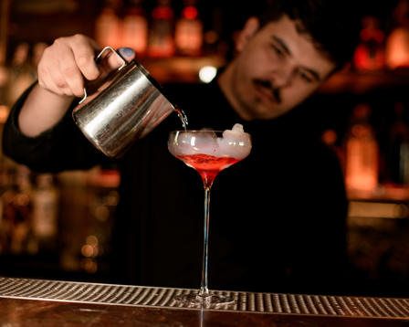 Bartender pours cocktail