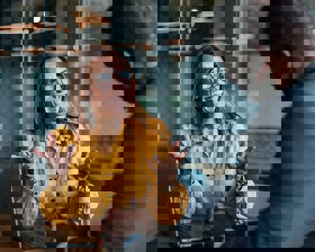 Businessman and businesswoman accountants sitting at a desk, discussing financial strategy using a laptop in the office.