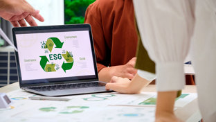 Laptop on business desk with ESG infographic