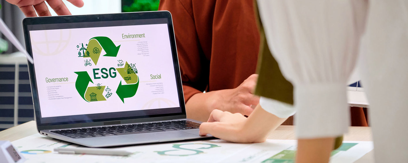 Laptop on business desk with ESG infographic