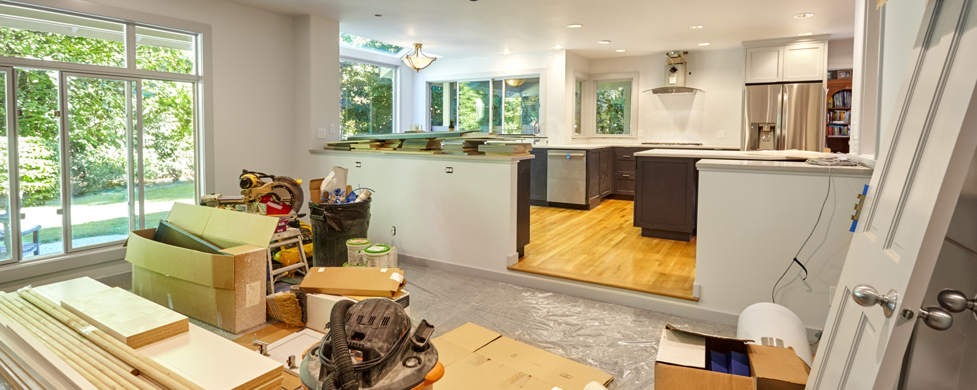 A room in the middle of renovation, with construction materials and tools scattered across the floor.
