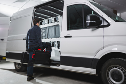 Worker entering into van with tools
