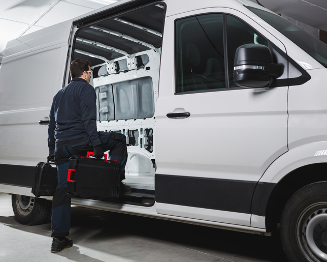 Worker entering into van with tools