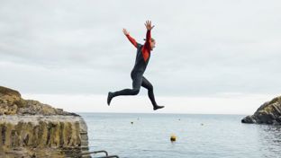 Person confidently jumping off a cliff