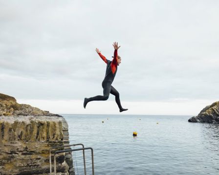 Person confidently jumping off a cliff