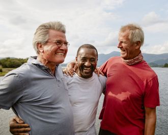 Group of people holding eachother taking a photo after succussfully completing an outdoor challenge