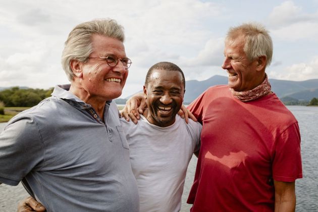 Group of people holding eachother taking a photo after succussfully completing an outdoor challenge