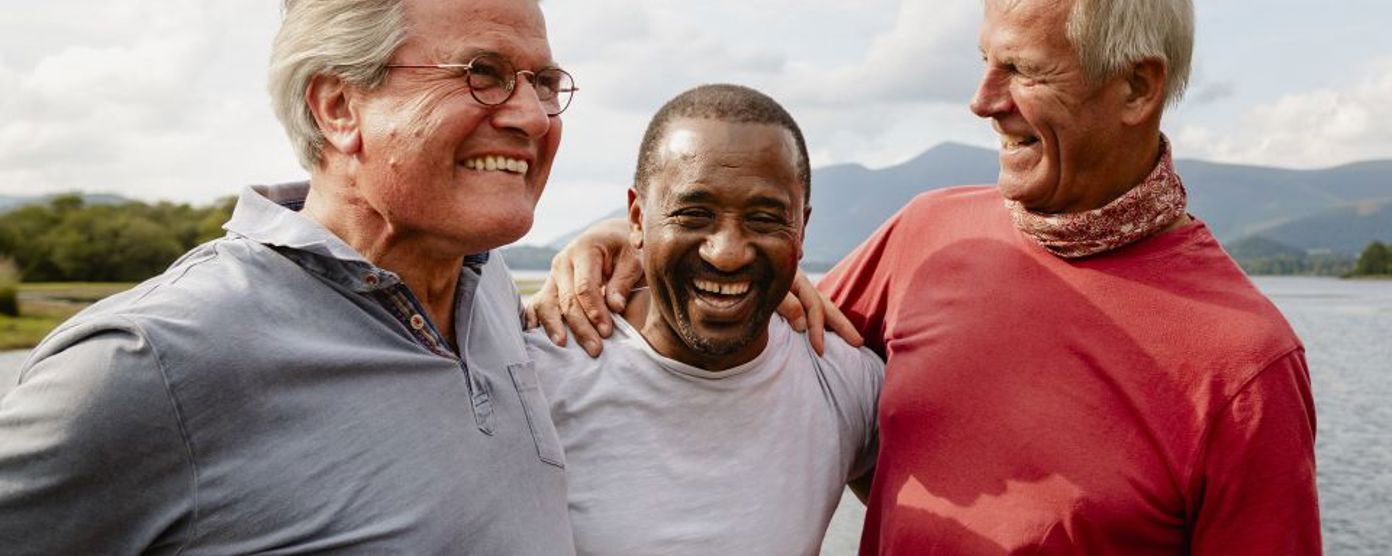 Group of people holding eachother taking a photo after succussfully completing an outdoor challenge