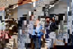 Real estate agent showing a house for sale to a couple.