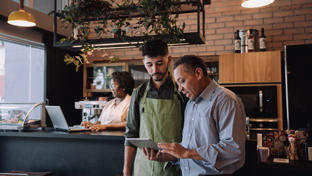 Coffee shop owner talking to employee
