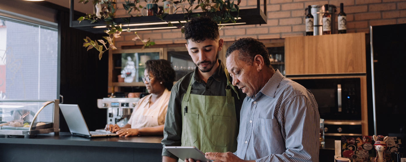 Coffee shop owner talking to employee