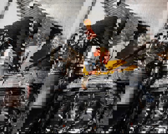 Mechanic repairing truck engine