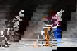 Sandblaster is sandblasting to steel material.